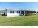 Charming home with an inviting backyard featuring a covered patio and manicured lawn at 3808 97Th N Ave, Pinellas Park, FL 33782