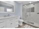 Bright bathroom featuring a new vanity and glass enclosed shower with decorative tile work at 3808 97Th N Ave, Pinellas Park, FL 33782