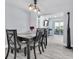 Dining room with modern light fixture, wood floors and view to screened patio at 3808 97Th N Ave, Pinellas Park, FL 33782