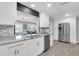 Bright kitchen with granite countertops, stainless steel appliances, and a view to the living area at 3808 97Th N Ave, Pinellas Park, FL 33782