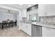 Modern kitchen featuring white cabinetry, granite countertops, and stainless steel dishwasher at 3808 97Th N Ave, Pinellas Park, FL 33782