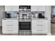 Well-equipped kitchen featuring stainless steel appliances, light countertops, and white cabinetry at 3808 97Th N Ave, Pinellas Park, FL 33782