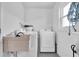 Laundry room with new washer and dryer, utility sink and hanging rack at 3808 97Th N Ave, Pinellas Park, FL 33782