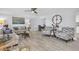 Inviting living room featuring wood-look floors, ceiling fan, and open view of the adjacent dining area at 3808 97Th N Ave, Pinellas Park, FL 33782