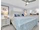 Spacious main bedroom with a ceiling fan, dresser, and bright natural lighting at 3808 97Th N Ave, Pinellas Park, FL 33782