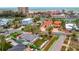 Aerial view showcases the house in proximity to the beach, hotels, and intercoastal waterways at 4151 Belle Vista Dr, St Pete Beach, FL 33706