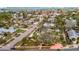 Aerial view of a quiet residential street featuring well-kept homes with mature trees and manicured lawns at 4151 Belle Vista Dr, St Pete Beach, FL 33706