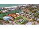 Aerial view showcases the house in proximity to the beach, hotels, and intercoastal waterways at 4151 Belle Vista Dr, St Pete Beach, FL 33706