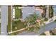 Aerial view of a home highlighting the well-manicured lawn, a patio, mature trees and lush landscaping at 4151 Belle Vista Dr, St Pete Beach, FL 33706