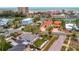 Aerial view highlighting homes near the water, creating a blend of residential comfort and coastal charm at 4151 Belle Vista Dr, St Pete Beach, FL 33706
