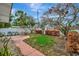 Cozy backyard space with a small lawn, patio area, and mature trees, perfect for relaxing at 4151 Belle Vista Dr, St Pete Beach, FL 33706