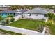 Well-maintained backyard with a neat lawn, white fence, and manicured landscaping at 4151 Belle Vista Dr, St Pete Beach, FL 33706