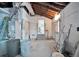Unfinished basement with block walls, exposed utilities, and doorway to the main living area at 4151 Belle Vista Dr, St Pete Beach, FL 33706