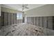 Bedroom with light ceiling fan, exposed walls and original wood flooring at 4151 Belle Vista Dr, St Pete Beach, FL 33706
