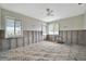 Bedroom awaiting renovation with natural light from two windows and a ceiling fan at 4151 Belle Vista Dr, St Pete Beach, FL 33706