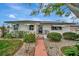Quaint home featuring a neatly landscaped front yard with inviting curb appeal at 4151 Belle Vista Dr, St Pete Beach, FL 33706
