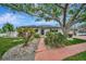 Charming home with a well-manicured lawn, lovely landscaping, and inviting entryway at 4151 Belle Vista Dr, St Pete Beach, FL 33706
