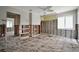 Living room featuring a ceiling fan, exposed framing and original floors at 4151 Belle Vista Dr, St Pete Beach, FL 33706