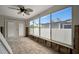 Sunroom with brick floors and large windows offering neighborhood views at 4151 Belle Vista Dr, St Pete Beach, FL 33706