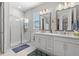 Bright bathroom featuring a glass enclosed shower and double sink vanity at 4600 Lagona Ln, Wesley Chapel, FL 33543