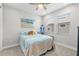 bedroom with colorful bedding, beach-themed artwork, and plenty of natural light at 4600 Lagona Ln, Wesley Chapel, FL 33543