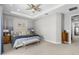 Neutral bedroom featuring tray ceilings, plush carpet, and decorative furnishings at 4600 Lagona Ln, Wesley Chapel, FL 33543