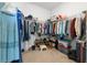 Walk-in closet featuring hanging racks for clothing and shoe storage at 4600 Lagona Ln, Wesley Chapel, FL 33543