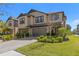 Attractive two-story home featuring a two-car garage, lovely landscaping, and a paver driveway at 4600 Lagona Ln, Wesley Chapel, FL 33543