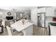 Open kitchen and living area with a large island, stainless steel appliances and plenty of seating at 4600 Lagona Ln, Wesley Chapel, FL 33543