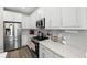 Bright kitchen with stainless steel appliances, white cabinets, and a stylish backsplash at 4600 Lagona Ln, Wesley Chapel, FL 33543