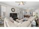 Inviting living room with comfortable seating, a large TV, and a view into the dining area at 4600 Lagona Ln, Wesley Chapel, FL 33543