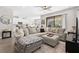 Open-concept living room and kitchen area with a large sofa and modern appliances at 4600 Lagona Ln, Wesley Chapel, FL 33543