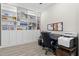 Well-lit office space with built-in bookshelves and a comfortable workspace, perfect for focus at 4600 Lagona Ln, Wesley Chapel, FL 33543