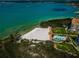 Stunning aerial view of a sandy beach, pool area, and luxurious waterfront condos surrounded by nature at 4801 Osprey S Dr # 508, St Petersburg, FL 33711