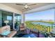 Relaxing waterfront balcony with comfortable seating, fan and scenic views at 4801 Osprey S Dr # 508, St Petersburg, FL 33711