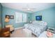 Relaxing bedroom featuring calming blue hues, a ceiling fan, and a charming window with blinds at 4801 Osprey S Dr # 508, St Petersburg, FL 33711