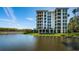 Stunning waterfront condominium buildings overlooking a serene lake, surrounded by lush greenery at 4801 Osprey S Dr # 508, St Petersburg, FL 33711