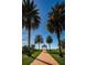 Majestic palm trees frame a brick pathway to a gazebo with stunning views of the serene bay waters at 4801 Osprey S Dr # 508, St Petersburg, FL 33711