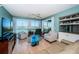 Light-filled living room with water views, ceiling fan, and comfortable seating at 4801 Osprey S Dr # 508, St Petersburg, FL 33711