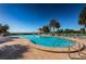 Large outdoor pool with chaise lounges and umbrellas, complemented by views of the tranquil bay and gazebo at 4801 Osprey S Dr # 508, St Petersburg, FL 33711