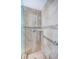 Modern tiled shower with handheld sprayer, built-in seat, and convenient grab bar at 4801 Osprey S Dr # 508, St Petersburg, FL 33711
