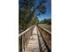 Picturesque wooden walkway lined with railings and lush greenery providing a scenic path at 4801 Osprey S Dr # 508, St Petersburg, FL 33711