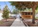 This backyard features a wooden bar, pergola dining area, beautiful landscaping, and a concrete walkway at 5010 45Th N Ave, St Petersburg, FL 33709