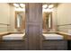 This bathroom has dual sinks, mirrors, and cabinets, offering ample storage and a modern aesthetic at 5010 45Th N Ave, St Petersburg, FL 33709