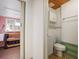 Cozy bathroom featuring white fixtures, a wood plank ceiling, and green accent tile at 5010 45Th N Ave, St Petersburg, FL 33709