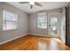 Bright bedroom with wood floors, mini-split AC, and a door to the outside at 5010 45Th N Ave, St Petersburg, FL 33709