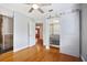 Sun-lit bedroom showcasing a glass enclosed shower, wood flooring, and a sliding door closet system at 5010 45Th N Ave, St Petersburg, FL 33709