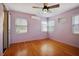 Bedroom with hardwood floors, ceiling fan, and window views at 5010 45Th N Ave, St Petersburg, FL 33709