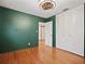 Spacious bedroom with hardwood floors, green walls, large closet, and access to other rooms at 5010 45Th N Ave, St Petersburg, FL 33709