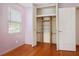 This bedroom features an open closet with built-in organizers, hardwood floors, and natural light at 5010 45Th N Ave, St Petersburg, FL 33709
